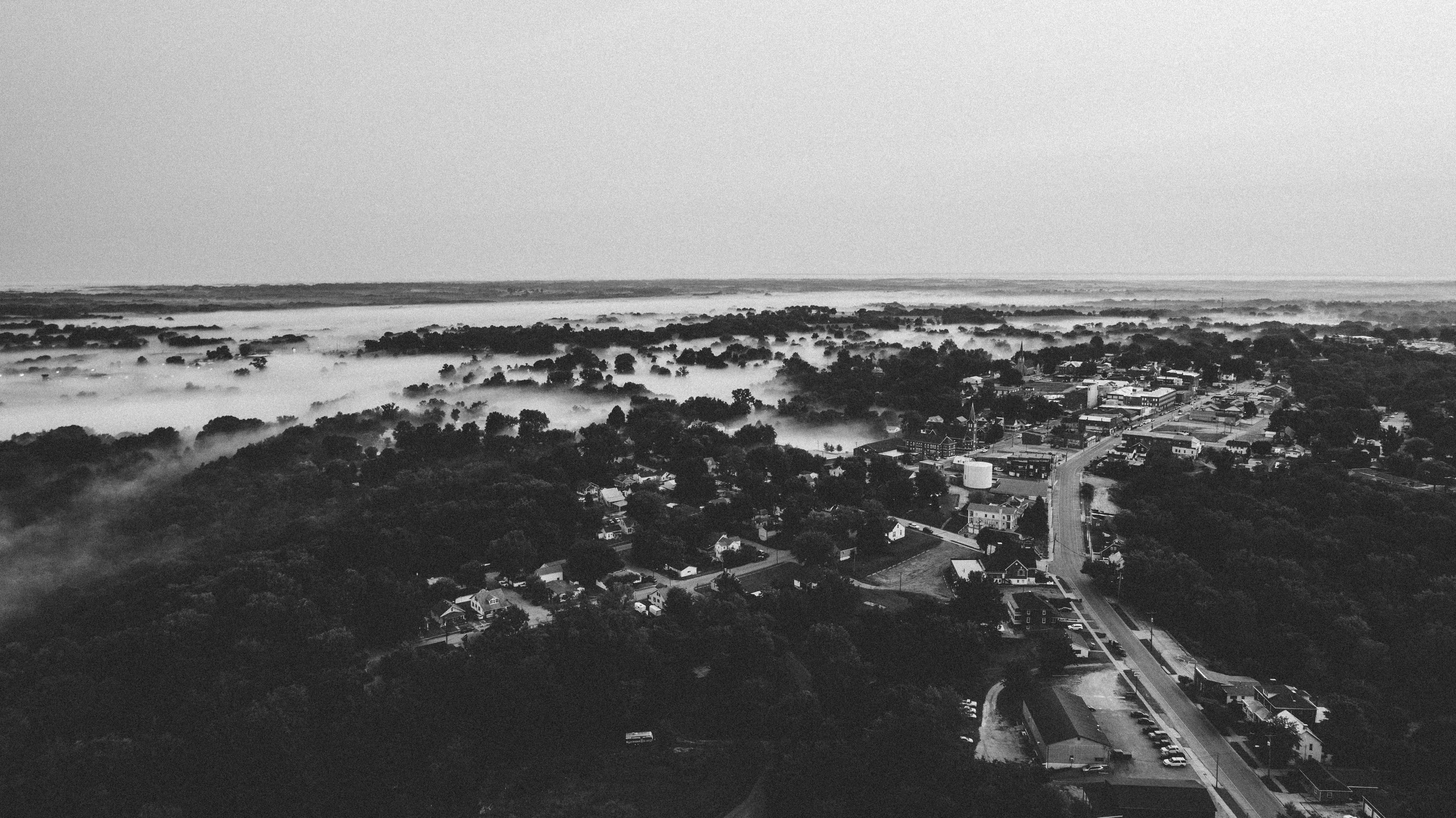 Black-and-white aerial view of Chester and fog across the surrounding lowlands